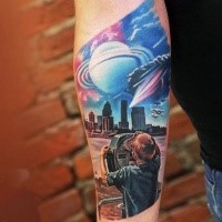 Futuristic illustrative style boy with city sights and planets tattoo on forearm