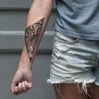 Geometrical black ink forearm tattoo of split tiger bu Valentin Hirsch