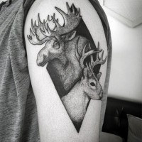 Geometrical shaped black ink tattoo on shoulder stylized with elk and deer