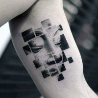 Geometrical style black ink biceps tattoo of Buddha portrait