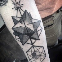 Geometrical style black ink forearm tattoo painted in dot style