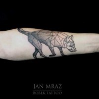 Geometrical style black ink wolf like tattoo on forearm zone