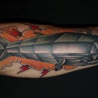 Geometrical style colored big iron like wale tattoo on arm