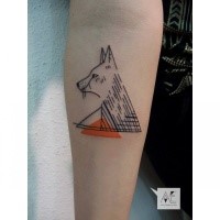 Geometrical style colored forearm tattoo of wolf with triangles