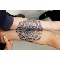 Geometrical style little black ink ornament tattoo on arm