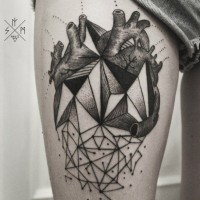 Geometrical style painted black and white heart tattoo on thigh