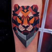 Geometrical style painted colored lion portrait tattoo on arm