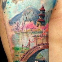 Glorious antic painting like colored Asian house in blooming garden tattoo on shoulder combined with mountain river and bridge