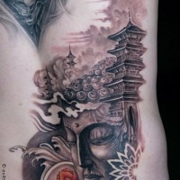 Glorious detailed Buddha statue tattoo on back with old temple and lotus