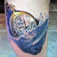 Golden colored broken under water clock tattoo on leg