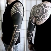 Gorgeous black and white detailed flower tattoo on shoulder stylized with tribal ornament on sleeve
