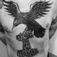 Gorgeous black ink chest and belly tattoo of big crow with Celtic cross