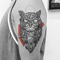 Gorgeous black ink owl tattoo on shoulder stylized with ornaments and colored triangles