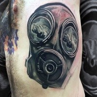 Gorgeous black ink side tattoo of gas mask