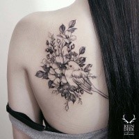 Gorgeous looking black outline style painted by Zihwa scapular tattoo of bird with flowers