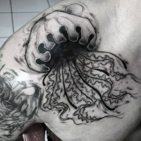 Gorgeous painted big black ink jellyfish tattoo on chest