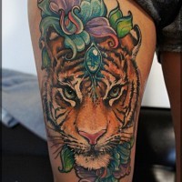 Gorgeous very beautiful colored natural looking tiger face tattoo on thigh stylized with flowers