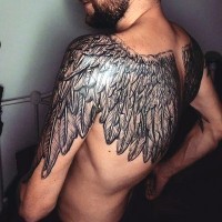 Gorgeous very detailed black and white wings tattoo on upper back and shoulders