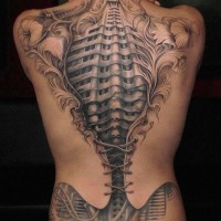 Gorgeous very detailed black and white human skeleton tattoo on hole back stylized with corset and flowers