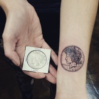Gorgeous very detailed little wrist tattoo of cool coin