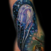 Gorgeous very realistic looking detailed colorful jellyfish tattoo on leg