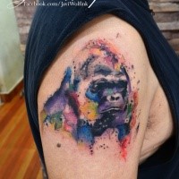 Gorilla's portrait with multicolored paint drips tattoo on upper arm in watercolor style by Javi Wolf