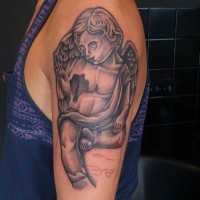 Gray ink little sitting cherub tattoo on shoulder