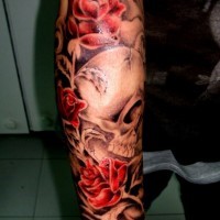 Gray skull with red roses forearm tattoo