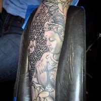 Gray washed style amazing looking forearm tattoo of Buddha statue and various ornaments