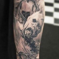 Gray washed style creepy looking monster scarecrow tattoo on forearm with old farm