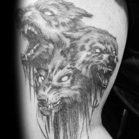 Gray washed style detailed biceps tattoo of Cerberus dog