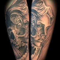 Gray washed style detailed forearm tattoo of crying woman stylized with skull