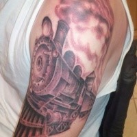 Gray washed style detailed upper arm tattoo of steam train