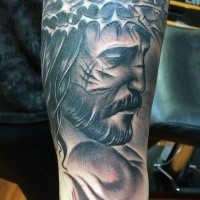 Gray washed style dramatic looking arm tattoo of sad Jesus portrait