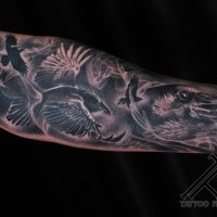 Gray washed style forearm tattoo of various crows