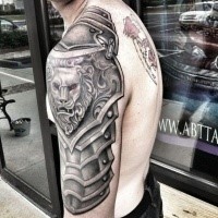 Gray washed style medieval shoulder armor tattoo stylized with lion