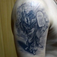 Gray washed style religious style shoulder tattoo of man with tablet