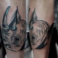 Gray washed style small rhino head tattoo on leg