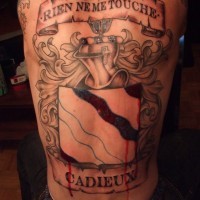 Tatuaje en la espalda, escudo grande con sangre y un letrero sobre él