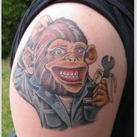 Great cartoon like monkey mechanic tattoo on upper arm