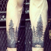 Great designed black and white big forest with bear tattoo on arm