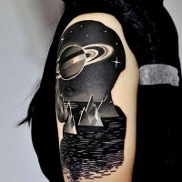 Great painted night ocean with big planet tattoo on shoulder