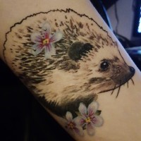 Great realistic gray-ink hedgehog with white flowers tattoo on arm