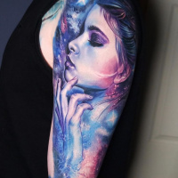 Great space and woman face tattoo on shoulder