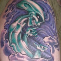 Green alien tattoo on shoulder