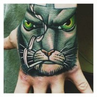 Tatuaje en la mano,  gato rebelde que fuma con ojos verdes