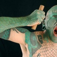 Green lizardman tattoo