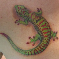 Green red gecko tattoo on back