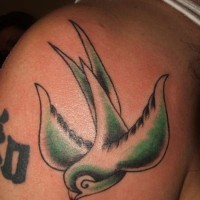 Green swallow bird tattoo on shoulder