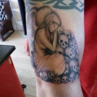 Grieving angel and skull tattoo on arm